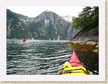 Alaska 526 * Robert paddles near the steep shoreline.  The vertical walls of the fjord are similar in proportion to those in Yosemite valley. * Robert paddles near the steep shoreline.  The vertical walls of the fjord are similar in proportion to those in Yosemite valley. * 1600 x 1200 * (885KB)